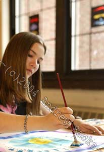 Girl paints in art classroom