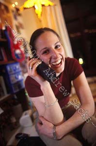 College girl on the phone in her dorm room