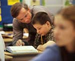 Elementary school teacher helps math class