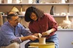 Art teacher with ceramics student 