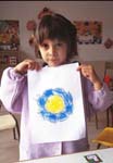 Pre-schooler shows off art work (Spain)