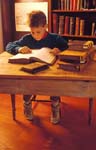 Boy reads antique books in library