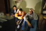 Three guys watch TV in their dorm room