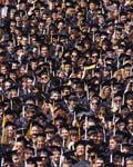 Crowd of graduates at college commencement 