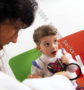 Female pediatrician examines child