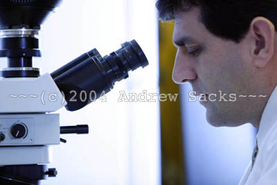 Medical researcher at microscope