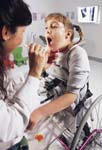 Pediatrician examines disabled patient